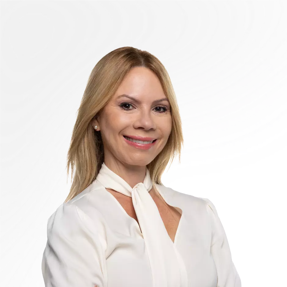 Professional portrait of a smiling blonde woman in a white blouse