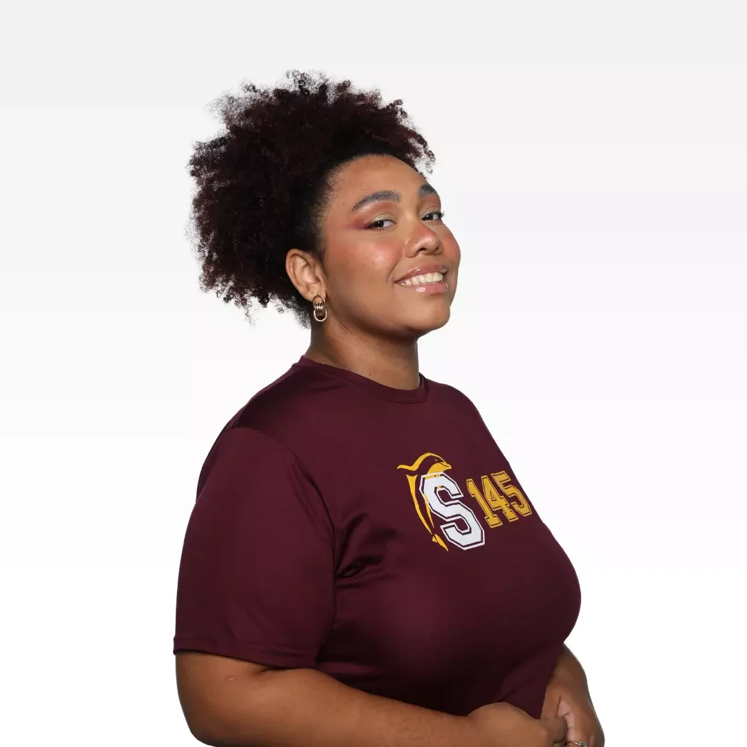 Smiling woman wearing a t-shirt Sagrado 145 years on a white background