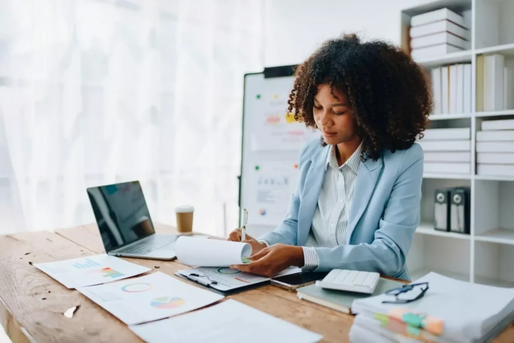 Professional reviewing financial reports in a bright office